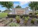 The stone entrance sign for Orchid Grove, featuring lush landscaping and welcoming signage, sets a tone of refined community living at 785 Orchid Grove Blvd, Davenport, FL 33837