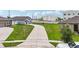A beautiful home with a long driveway, well-maintained lawn, and curb appeal at 785 Orchid Grove Blvd, Davenport, FL 33837