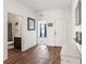 Inviting entryway with hardwood floors, decorative furniture, and an open view at 785 Orchid Grove Blvd, Davenport, FL 33837