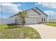 Charming single-story home boasts a two-car garage, manicured lawn, and welcoming curb appeal at 785 Orchid Grove Blvd, Davenport, FL 33837