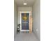 Welcoming front porch with decorative wreath, welcome sign, and potted plants at 785 Orchid Grove Blvd, Davenport, FL 33837