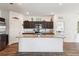 The spacious kitchen with dark wood cabinets and a granite-topped island at 785 Orchid Grove Blvd, Davenport, FL 33837