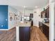 Open concept kitchen featuring granite countertops and modern appliances at 785 Orchid Grove Blvd, Davenport, FL 33837