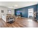 Comfortable living room with a cozy couch, modern flooring, and a large accent wall at 785 Orchid Grove Blvd, Davenport, FL 33837