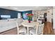 Open-concept living area featuring a modern table with seating, couch, and stylish decor at 785 Orchid Grove Blvd, Davenport, FL 33837