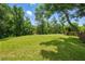 Expansive backyard with lush green lawn, mature trees, and plenty of space for outdoor activities at 841 Wesson Ct, Casselberry, FL 32707