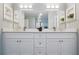 Bathroom with double vanity, framed mirrors, and white cabinetry for plenty of storage space at 841 Wesson Ct, Casselberry, FL 32707