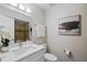 Bathroom featuring a white vanity, framed mirror, and walk-in shower with neutral stone finishes at 841 Wesson Ct, Casselberry, FL 32707