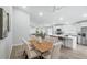 Open-concept dining area with seating for six and adjacent kitchen featuring stainless steel appliances and a center island at 841 Wesson Ct, Casselberry, FL 32707