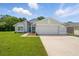 Charming single-story home featuring a well-manicured lawn, a two-car garage, and a welcoming blue front door at 841 Wesson Ct, Casselberry, FL 32707