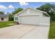 Angle view of the home showcasing a two-car garage, manicured landscaping, and a light blue paint color at 841 Wesson Ct, Casselberry, FL 32707