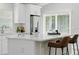 Modern kitchen with white cabinets, stainless steel appliances, and a center island with bar seating at 841 Wesson Ct, Casselberry, FL 32707