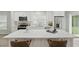 Open kitchen with a central island featuring quartz countertops, seating, and modern fixtures at 841 Wesson Ct, Casselberry, FL 32707