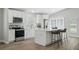 Well-appointed kitchen with white cabinetry, stainless steel appliances, and a breakfast bar for casual dining at 841 Wesson Ct, Casselberry, FL 32707