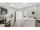 Modern kitchen featuring white cabinets, stainless steel appliances, and a large island with seating at 841 Wesson Ct, Casselberry, FL 32707