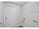 Bright laundry room featuring a white door, shelving, wood-look flooring, and utility connections at 841 Wesson Ct, Casselberry, FL 32707