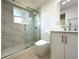Modern bathroom featuring a glass-enclosed shower with rain shower head at 910 Flamingo Dr, Leesburg, FL 34748