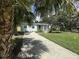 Charming single-story home with well-maintained landscaping and a private driveway at 910 Flamingo Dr, Leesburg, FL 34748