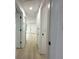 Bright hallway with hardwood floors, white trim and doors at 910 Flamingo Dr, Leesburg, FL 34748