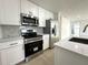 Modern kitchen featuring stainless steel appliances and white cabinetry at 910 Flamingo Dr, Leesburg, FL 34748