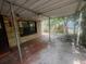 Covered back porch with brick accent wall and ceiling fan overlooks the backyard at 4250 Lake Ave, Kissimmee, FL 34746