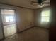 Bedroom with wall accents, tile floors, view to another room and natural light from two windows at 4250 Lake Ave, Kissimmee, FL 34746