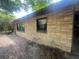 Side exterior view of a home with tan brick and black window trim with natural light at 4250 Lake Ave, Kissimmee, FL 34746