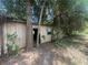 View of the exterior of shed partially obstructed by mature landscaping at 4250 Lake Ave, Kissimmee, FL 34746