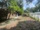 View of yard with mature trees and partially obstructed view of brick home exterior at 4250 Lake Ave, Kissimmee, FL 34746