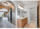 Bathroom featuring wooden vanity with sink and mirror, with access to a shower room at 100 Monterey Oaks Dr, Sanford, FL 32771