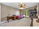 Cozy bedroom with a ceiling fan, large window, desk and shelving at 100 Monterey Oaks Dr, Sanford, FL 32771