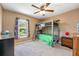 Bright bedroom featuring a unique bunk bed, window, ceiling fan, and neutral carpet at 100 Monterey Oaks Dr, Sanford, FL 32771