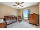 Bedroom featuring a crib, chair, dresser, and window allowing natural light at 100 Monterey Oaks Dr, Sanford, FL 32771
