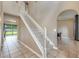 Bright foyer with tile flooring, staircase, and archways leading to other rooms at 100 Monterey Oaks Dr, Sanford, FL 32771