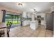 Spacious kitchen with an island, stainless steel appliances, granite countertops and sliding door to screened lanai at 100 Monterey Oaks Dr, Sanford, FL 32771