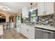 Bright kitchen with white cabinets, mosaic backsplash, stainless steel appliances and bar seating at 100 Monterey Oaks Dr, Sanford, FL 32771
