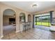 Open kitchen with a bar overlooking the dining area and sliding glass doors to the screened lanai at 100 Monterey Oaks Dr, Sanford, FL 32771