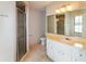 Clean bathroom featuring a glass-enclosed shower, tiled floors, and a vanity with a mirror at 10448 Sw 74Th Ct, Ocala, FL 34476