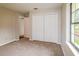 Carpeted bedroom with a large closet, window, and neutral color palette at 10448 Sw 74Th Ct, Ocala, FL 34476