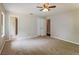 Spacious carpeted bedroom with ceiling fan, closet, and access to an en-suite bathroom at 10448 Sw 74Th Ct, Ocala, FL 34476