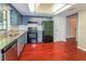 Well-equipped kitchen featuring gray cabinets, stainless steel appliances, granite countertops, and hardwood floors at 10448 Sw 74Th Ct, Ocala, FL 34476