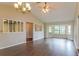 Spacious living room with hardwood floors, lots of natural light, ceiling fan, and chandelier at 10448 Sw 74Th Ct, Ocala, FL 34476