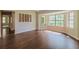Bright living room featuring hardwood floors and large windows providing ample natural light at 10448 Sw 74Th Ct, Ocala, FL 34476
