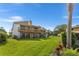 Spacious backyard featuring a lush green lawn, a charming balcony, and a peaceful outdoor living space at 1051 S Highland St # 7D, Mount Dora, FL 32757