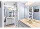 Bathroom with double sink vanity, open door with view to second bathroom, and good lighting at 1051 S Highland St # 7D, Mount Dora, FL 32757