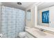 Bathroom with shower/tub, toilet, white vanity, blue accents, and good lighting at 1051 S Highland St # 7D, Mount Dora, FL 32757