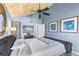 Stylish bedroom features blue walls, decorative ceiling, and a queen-sized bed with plush bedding at 1051 S Highland St # 7D, Mount Dora, FL 32757