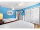 Inviting bedroom showcasing twin beds, a dresser, and closet space with light-colored walls and matching linens at 1051 S Highland St # 7D, Mount Dora, FL 32757
