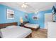 Bright bedroom with two twin beds, wooden furniture, and a serene blue color scheme at 1051 S Highland St # 7D, Mount Dora, FL 32757