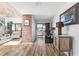 Hallway featuring wood floors, brick accent wall, and a view of the balcony at 1051 S Highland St # 7D, Mount Dora, FL 32757
